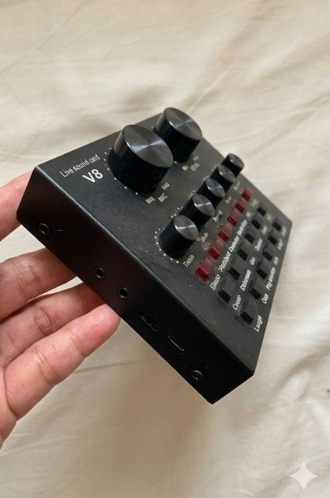 V8 Live Sound Card Audio Mixer (Category: Other Audio Equipment) located in Quezon City. Submitted by SustainableFashionatbp (Listing ID 1461941216, Image 3). Description: - V8 Live Sound Card - Controls for Mic and Echo levels - Knobs for Treble, Bass, Record, Music, and Monitor - Multiple Sound Effect buttons (Electro, Pitch Bend, Gun, Kiss, etc.) - Ideal for Live Streaming and Recording --Lost cables and boom mic stand.