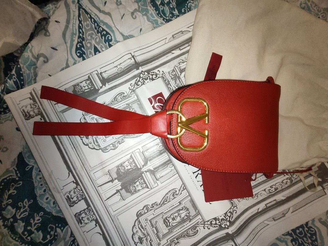 VALENTINO VRING CROSS BODY BAG (Category: Cross-body Bags) located in Valenzuela. Submitted by kchinadol (Listing ID 1461802332, Image 3). Description: Valentino VRING Crossbody Bag Red Leather Gold-Tone Hardware Shoulder Strap Braided Accents & Single Exterior Pocket Suede Lining & Single Interior Pocket Snap Closure at Front Inclusions: dust bag and care card.