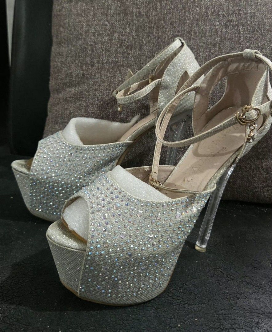 Venus Sparkly Platform Heels with Ankle Strap (Category: Heels) located in Quezon City. Submitted by kctheexplorer05 (Listing ID 1461863068, Image 2). Description: - Silver sparkly platform heels - Ankle strap with buckle closure - Clear block heel - Size 42 / 6 inches heels - Shows some wear on insoles and soles (see photos for reference) - Ideal for parties, special occasions, pageants .
