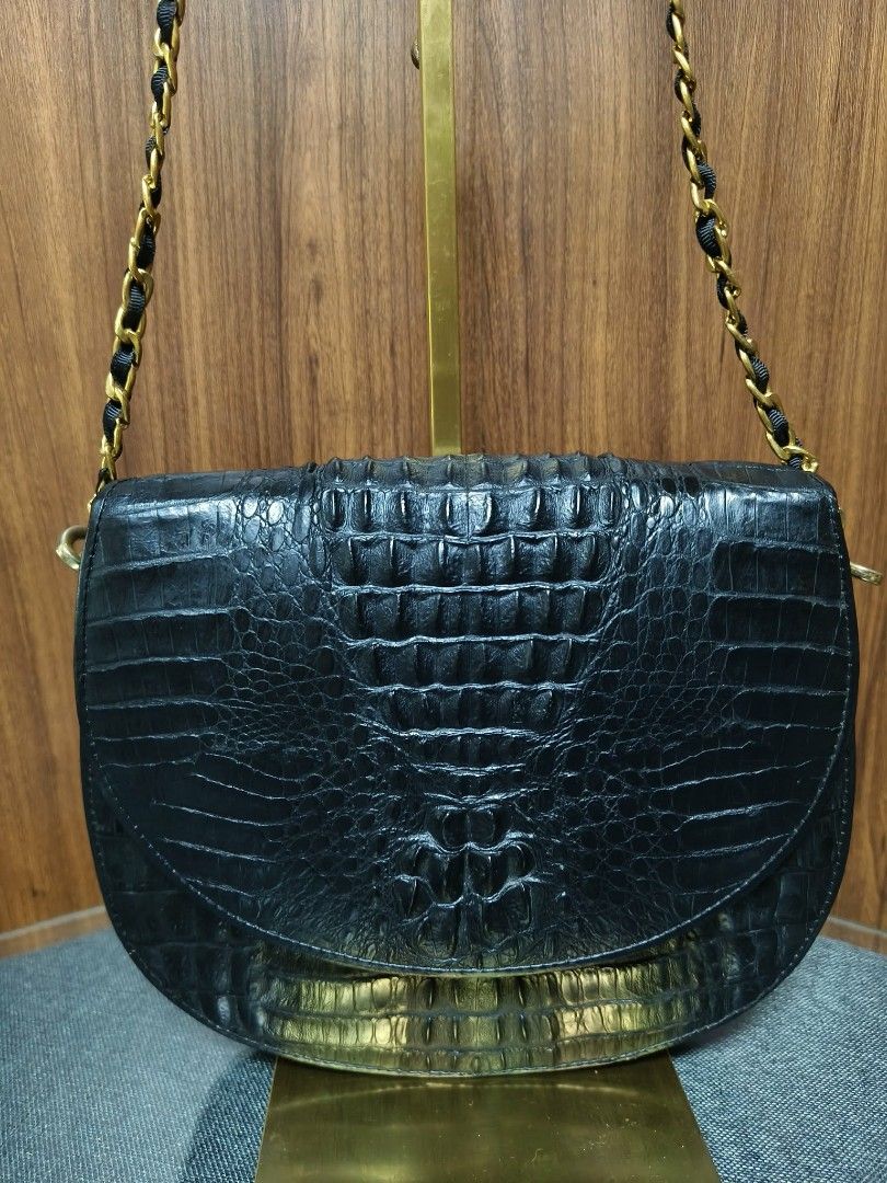 Vintage Black Crocodile Saddle Bag (Category: Cross-body Bags) located in Baguio. Submitted by amagenbagsfashionshop (Listing ID 1461922973, Image 2). Description: Vintage Black Crocodile Saddle Bag Good used condition with normal signs of wear. Back hornback Crocodile skin, structured curved saddle silhouette, and a multi-compartment interior with a secure zip pocket. Note: The chic leather-woven chain strap is a non-original replacement that ma