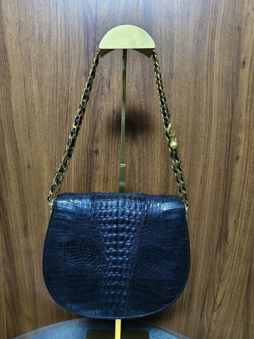 Vintage Black Crocodile Saddle Bag (Category: Cross-body Bags) located in Baguio. Submitted by amagenbagsfashionshop (Listing ID 1461922973, Image 3). Description: Vintage Black Crocodile Saddle Bag Good used condition with normal signs of wear. Back hornback Crocodile skin, structured curved saddle silhouette, and a multi-compartment interior with a secure zip pocket. Note: The chic leather-woven chain strap is a non-original replacement that ma