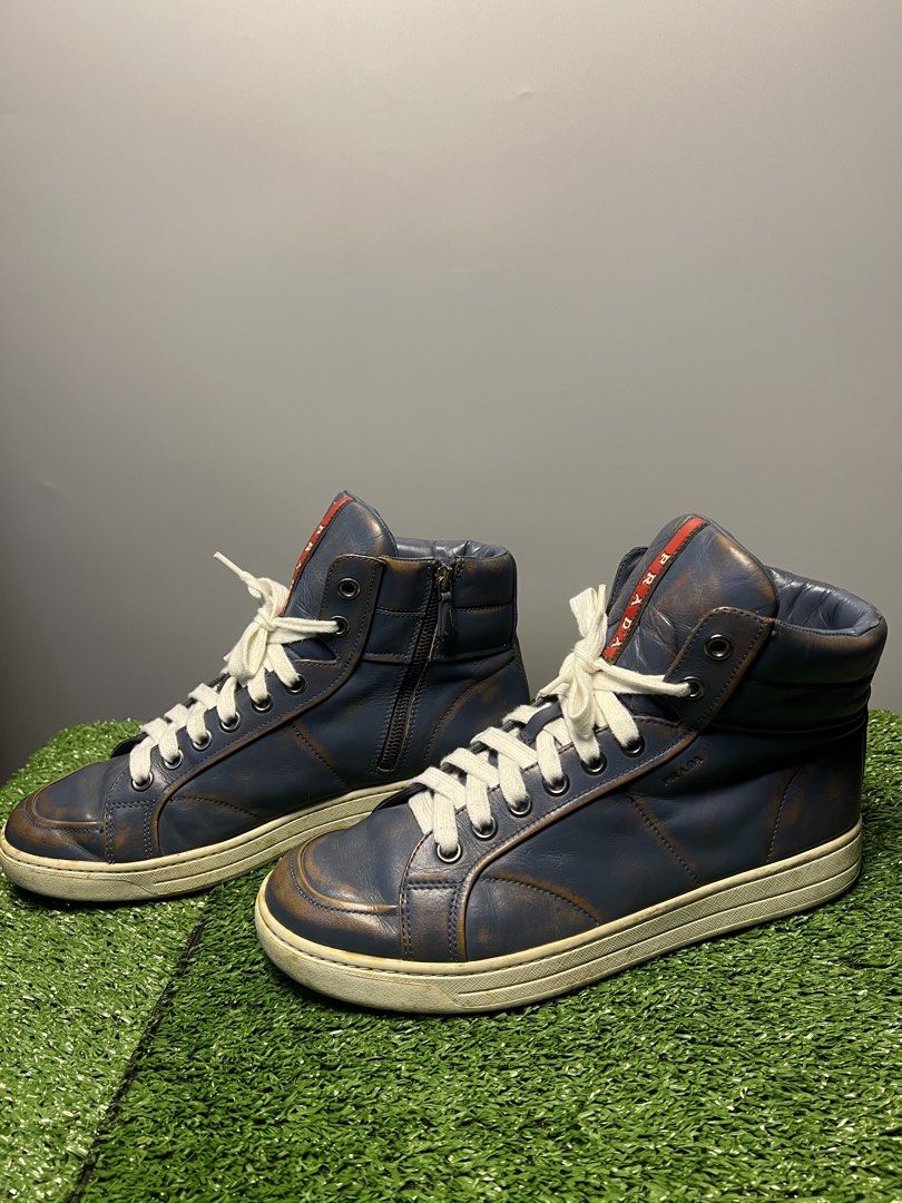 VINTAGE PRADA - DISTRESSED LEATHER HIGH TOP SNEAKERS (Category: Sneakers & Footwear) located in Bacolod City. Submitted by timelessbyjosh (Listing ID 1461969919, Image 3). Description: BEST FOR AVANT GARDE & STREETWEAR OUTFITS SIZE : 7 ACTUAL COLOR : COLOR RATE : 9 OUT OF 10 CONDITION : WELL USED MATERIAL : LIGHT NAVY BLUE MADE IN : VIETNAM FLAWS : YELLOWING ON THE SOLE, DISTRESSED LEATHER ( ADDS A CHARACTER ) , SHOELACE NEED CLEANING & MINIMAL S