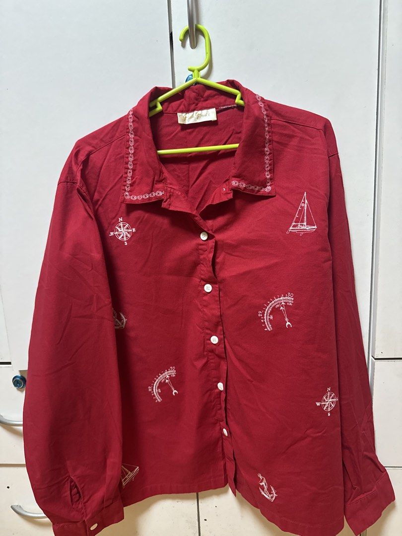 Vintage Red Nautical Print Button-Up Shirt (Category: Coats, Jackets and Outerwear) located in Manila. Submitted by quintessesommerset (Listing ID 1462026989, Image 1). Description: - Sophia Brooks red long-sleeved shirt 23x27.5 - Nautical print featuring compasses, sailboats, and anchors - Button-up front with white buttons - Unique chain-link embroidery detail on the collar - Ideal for a casual, preppy aesthetic.