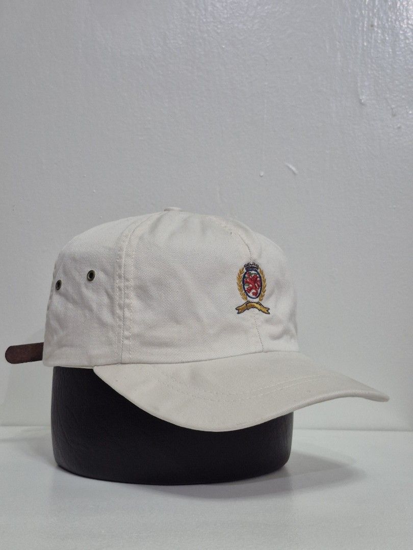 Vintage Tommy Hilfiger dad hat | with issues (Category: Caps & Hats) located in Pasay City. Submitted by blackmarket074 (Listing ID 1462016218, Image 1). Description: - Classic white baseball cap - Features an embroidered crest on the front - Adjustable leather strap at the back - Simple and versatile design for day use Conditions & issues *see photos for references .