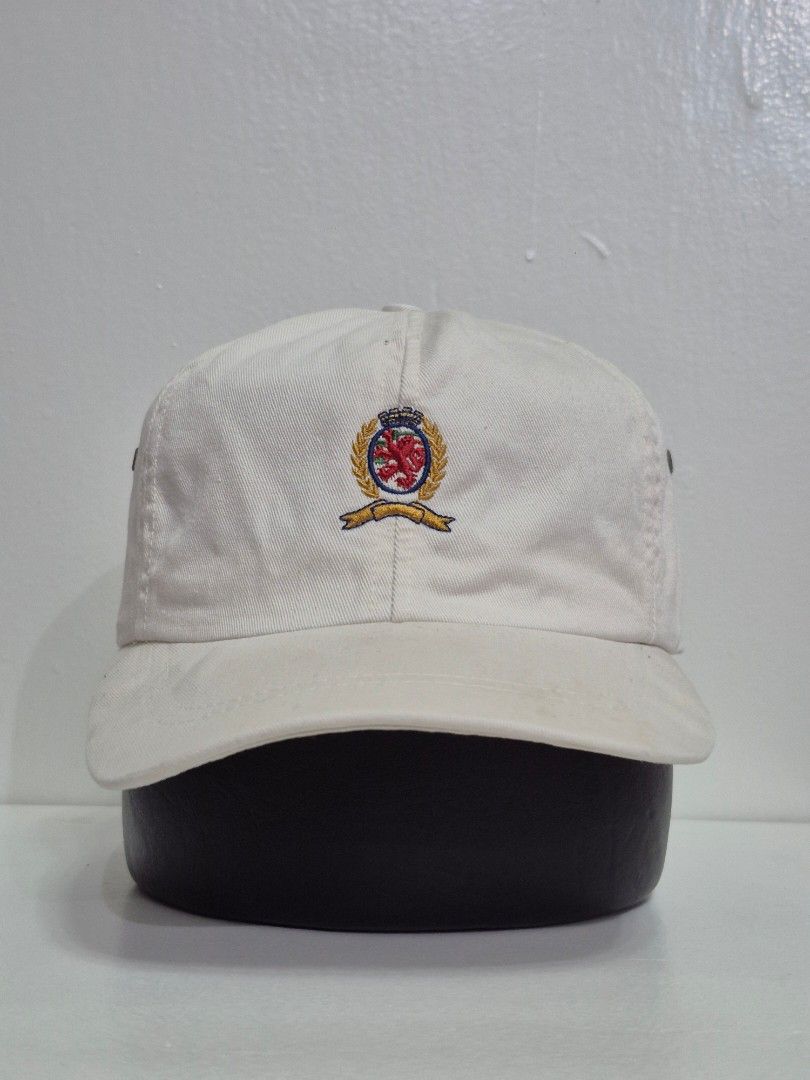 Vintage Tommy Hilfiger dad hat | with issues (Category: Caps & Hats) located in Pasay City. Submitted by blackmarket074 (Listing ID 1462016218, Image 2). Description: - Classic white baseball cap - Features an embroidered crest on the front - Adjustable leather strap at the back - Simple and versatile design for day use Conditions & issues *see photos for references .