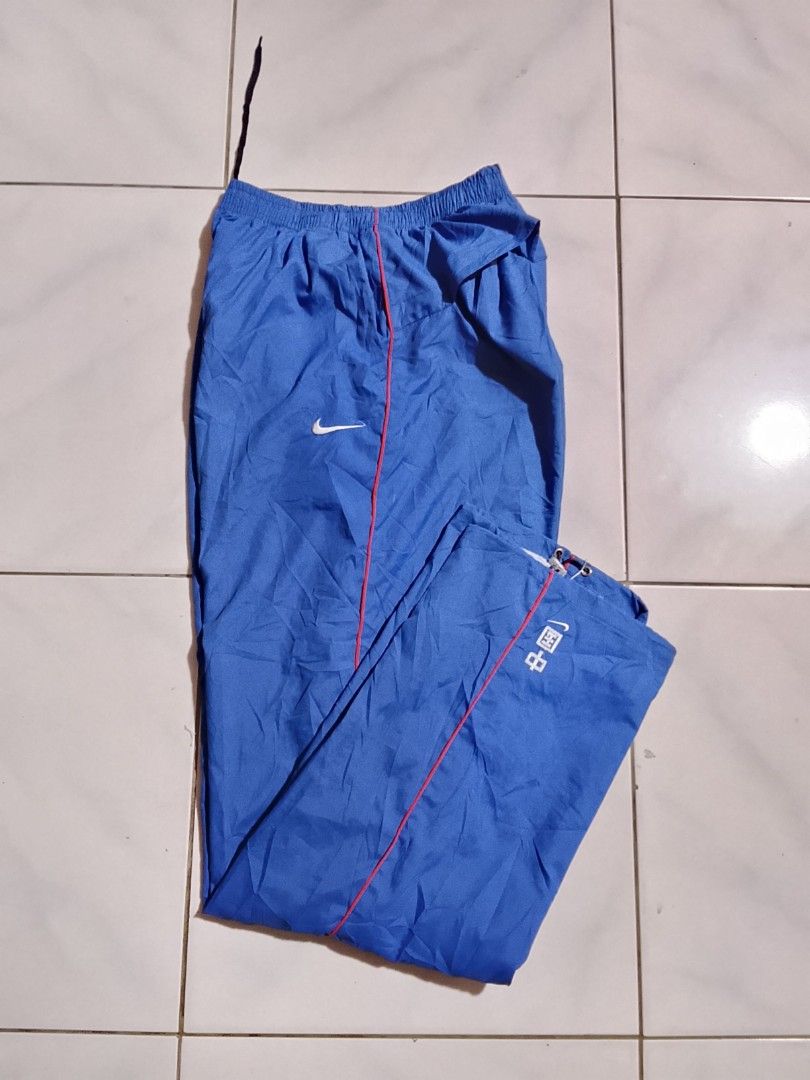 Vintage y2k Nike pants embroid (Category: Joggers) located in Cavite. Submitted by ara.thrifts (Listing ID 1461813604, Image 1). Description: - Blue Nike track pants - Chinese characters and Nike logo on the left leg 2xl width "17" length "41" no issue bnew 10/10 cr.