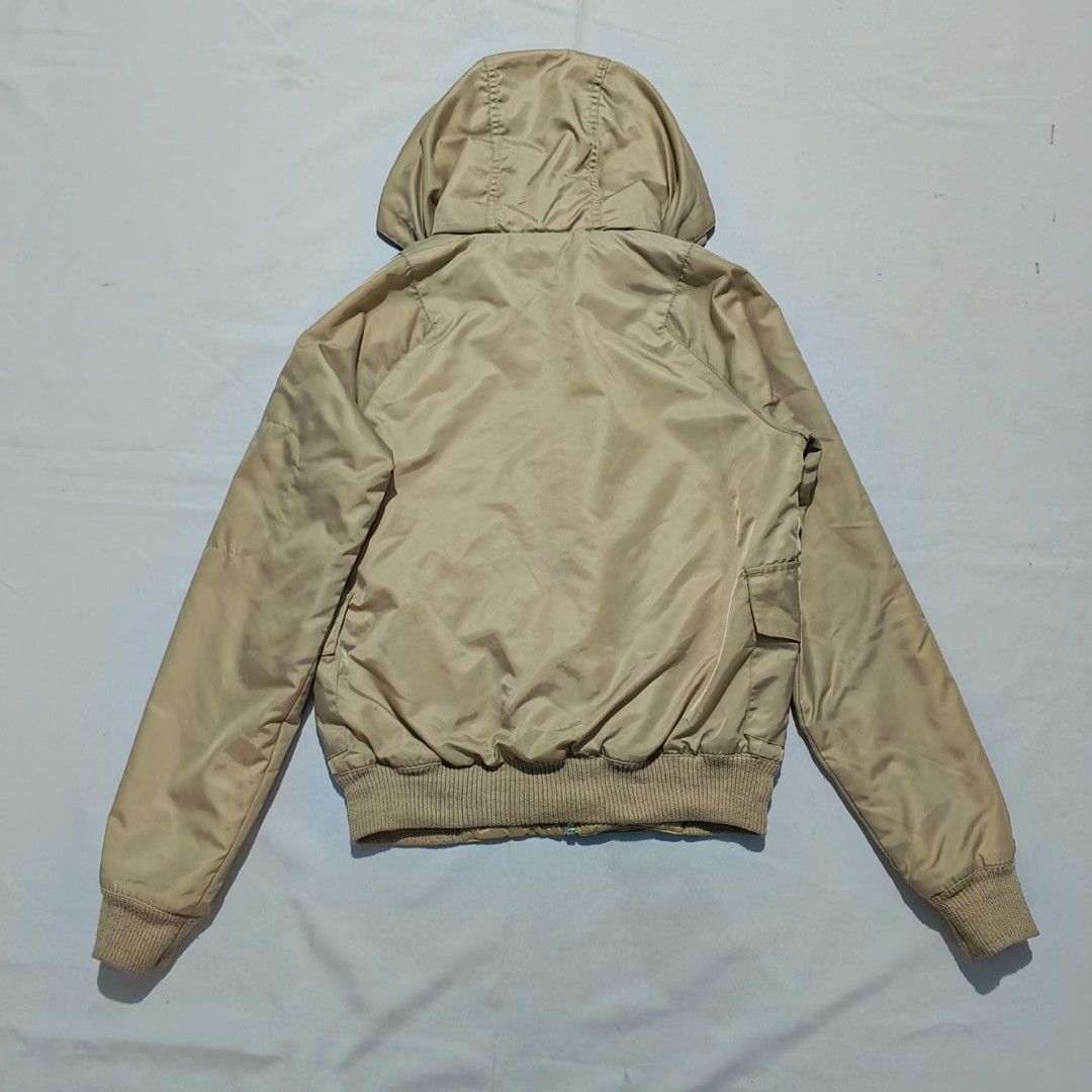 VINTAGE-STYLE DC Hooded Bomber/Windbreaker Jacket (Category: Coats, Jackets and Outerwear) located in Baguio. Submitted by mir_yam.elias (Listing ID 1461958564, Image 2). Description: ‎DC Hooded Bomber/Windbreaker Jacket ‎vintage-style hooded nylon Bomber/Windbreaker jacket beige in color featuring a front zipper, ribbed hem and cuffs, dual front flap pockets, and a utility pocket on the sleeve ‎Fits S on Mens; S-M womens ‎S on tag ‎W 51.5 cm ‎Ne