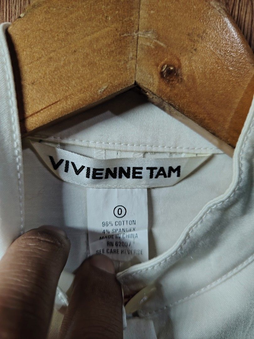 Vivienne Tam White Cropped Jacket Size 0 (Category: Coats, Jackets and Outerwear) located in Baguio. Submitted by angeloshoppebaguio2600 (Listing ID 1461981567, Image 2). Description: - Vivienne Tam cropped jacket - Color: White - Material: 96% Cotton, 4% Spandex - Style: Mandarin collar, button-up front - Sleeves: Three-quarter length - Pockets: Two front pockets with button closure - Detail: Small red accent on pocket - Care: Professional dry c