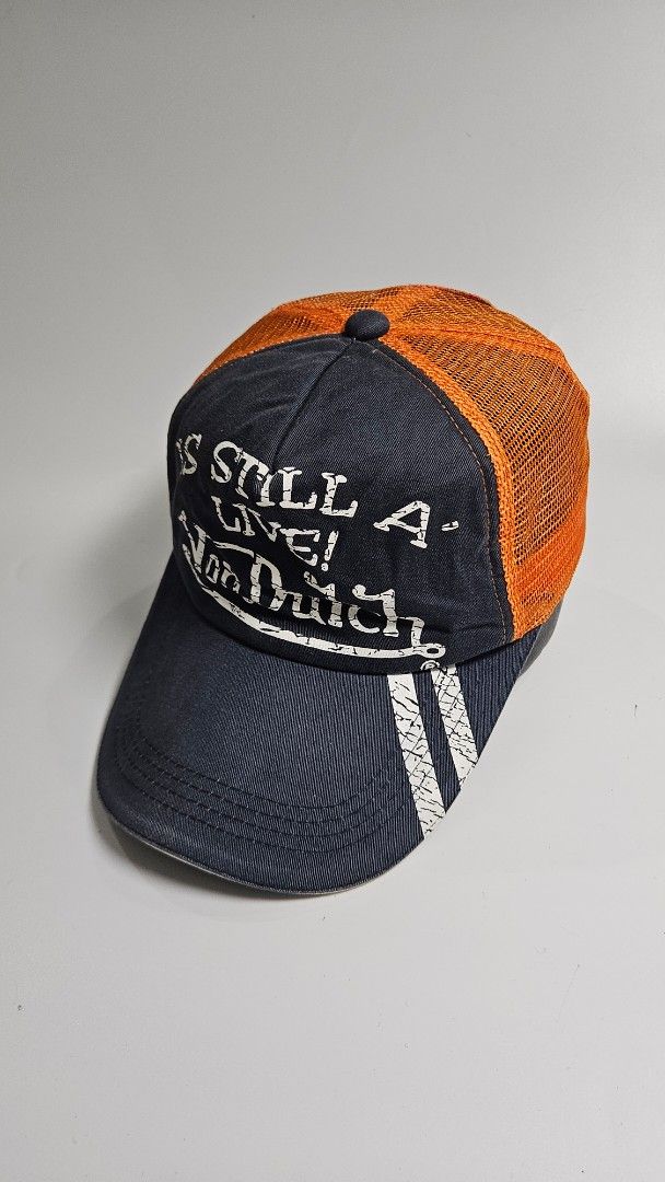 Von Dutch Trucker Cap Orange Mesh Navy Blue (Category: Caps & Hats) located in Alfonso. Submitted by jbcamet (Listing ID 1461934782, Image 2). Description: - Classic Von Dutch trucker cap - Features orange mesh back and navy blue front panel - "Still Live" graphic prominently displayed on the front - Adjustable snapback closure for a custom, comfortable fit - One size fits most, ideal for everyday casual wear.