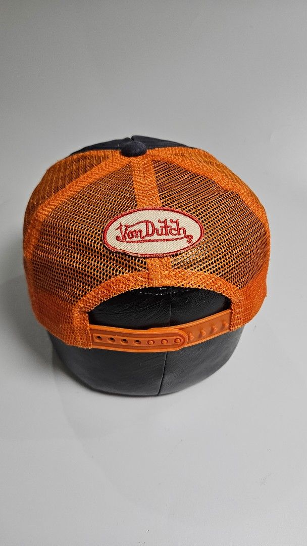 Von Dutch Trucker Cap Orange Mesh Navy Blue (Category: Caps & Hats) located in Alfonso. Submitted by jbcamet (Listing ID 1461934782, Image 3). Description: - Classic Von Dutch trucker cap - Features orange mesh back and navy blue front panel - "Still Live" graphic prominently displayed on the front - Adjustable snapback closure for a custom, comfortable fit - One size fits most, ideal for everyday casual wear.