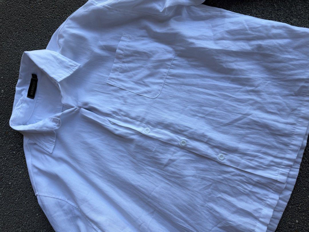 White Boxy Cropped Long Sleeve Button Up Shirt (Category: Tshirts & Polo Shirts ) located in San Fernando. Submitted by houseof_jj (Listing ID 1462030913, Image 3). Description: USED ONCE SIZE: L - White long sleeve shirt from MANNERED - Features a collar and a single chest pocket - Button-up front closure - Relaxed fit for comfort - Versatile for casual wear or layering - Easy to style with any outfit.