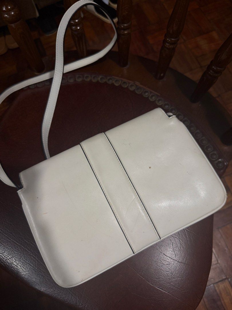 White Gucci sling bag (Category: Luxury Bags & Wallets) located in Pinamalayan. Submitted by braveheartfiftyfive (Listing ID 1461872532, Image 2). Description: - white leather Gucci shoulder bag - Iconic gold-tone GG logo hardware - Adjustable shoulder strap with buckle - Interior: zip pocket and main compartment - Secure magnetic snap closure - Minor marks on exterior leather (please check photos) - Interior is clean.