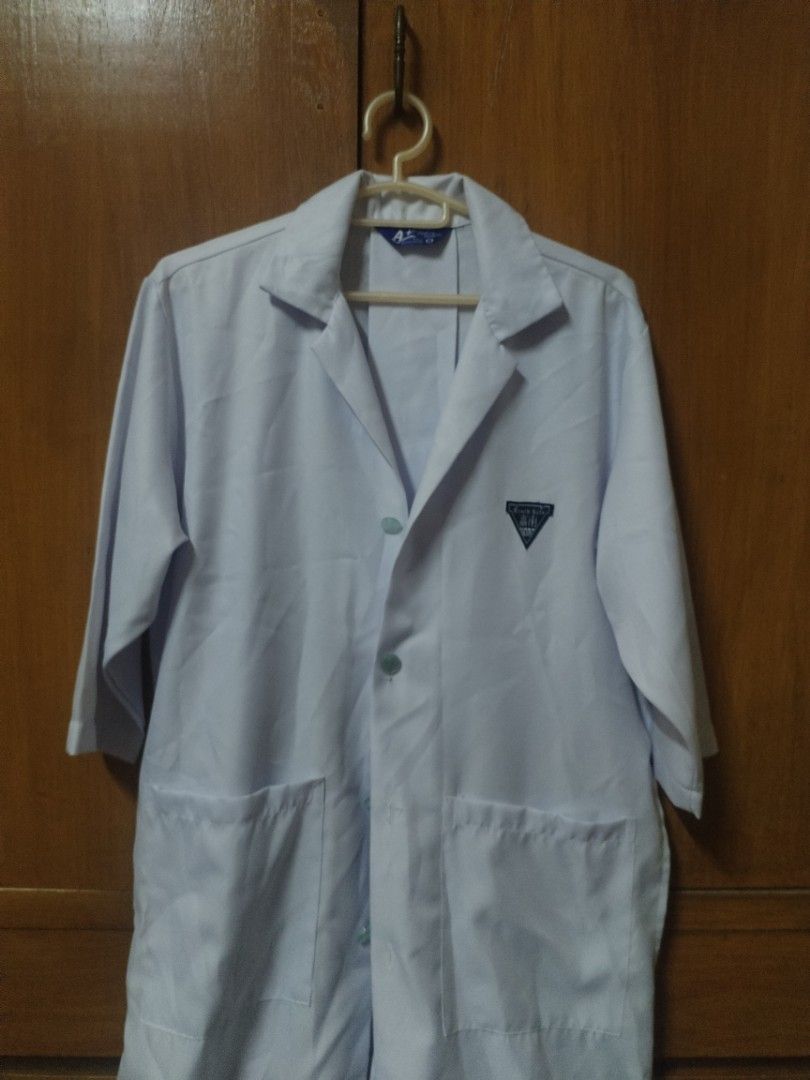 White Lab Coat (Category: Coats, Jackets and Outerwear) located in Manila. Submitted by patrickdeclutters (Listing ID 1461869626, Image 1). Description: - Classic white lab coat - Button-down front closure - Two functional lower front pockets - Small emblem detail on the left chest - Comfortable three-quarter sleeves - Stylish back pleat for ease of movement - Ideal for science classes, lab work, or experiments.