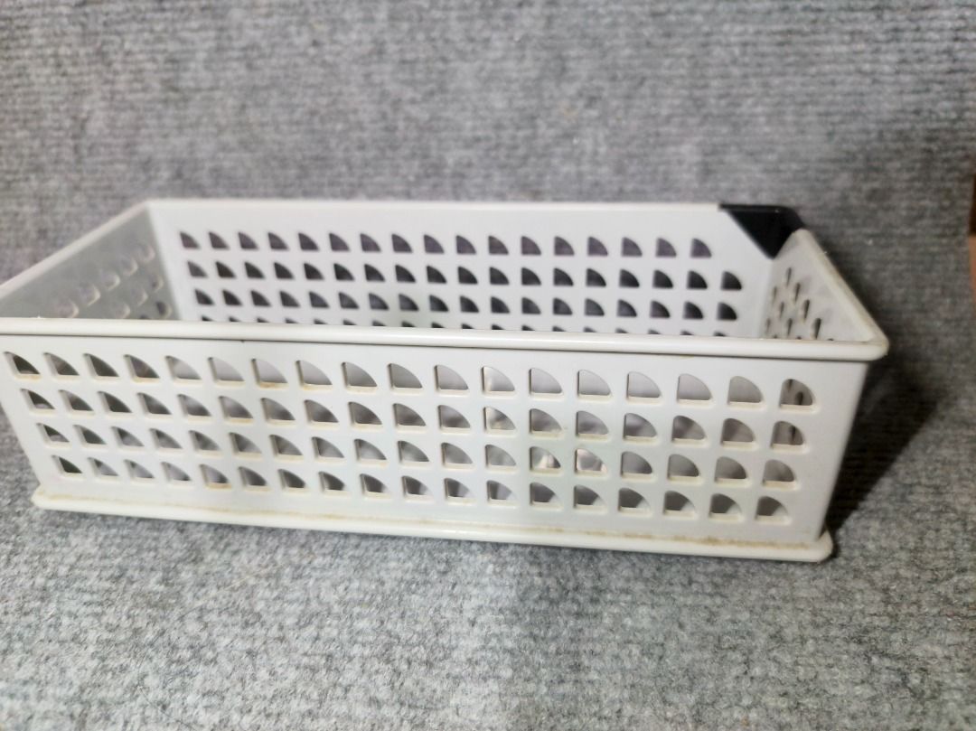 White Plastic Storage Basket Organizer (Category: Storage Boxes & Baskets) located in San Leonardo. Submitted by burgossanleonardo.12345 (Listing ID 1461857250, Image 1). Description: - White plastic storage basket - Perforated design on sides - Ideal for organizing small desk or shelf items - Black plastic corner protectors - Approximately 24cm long.