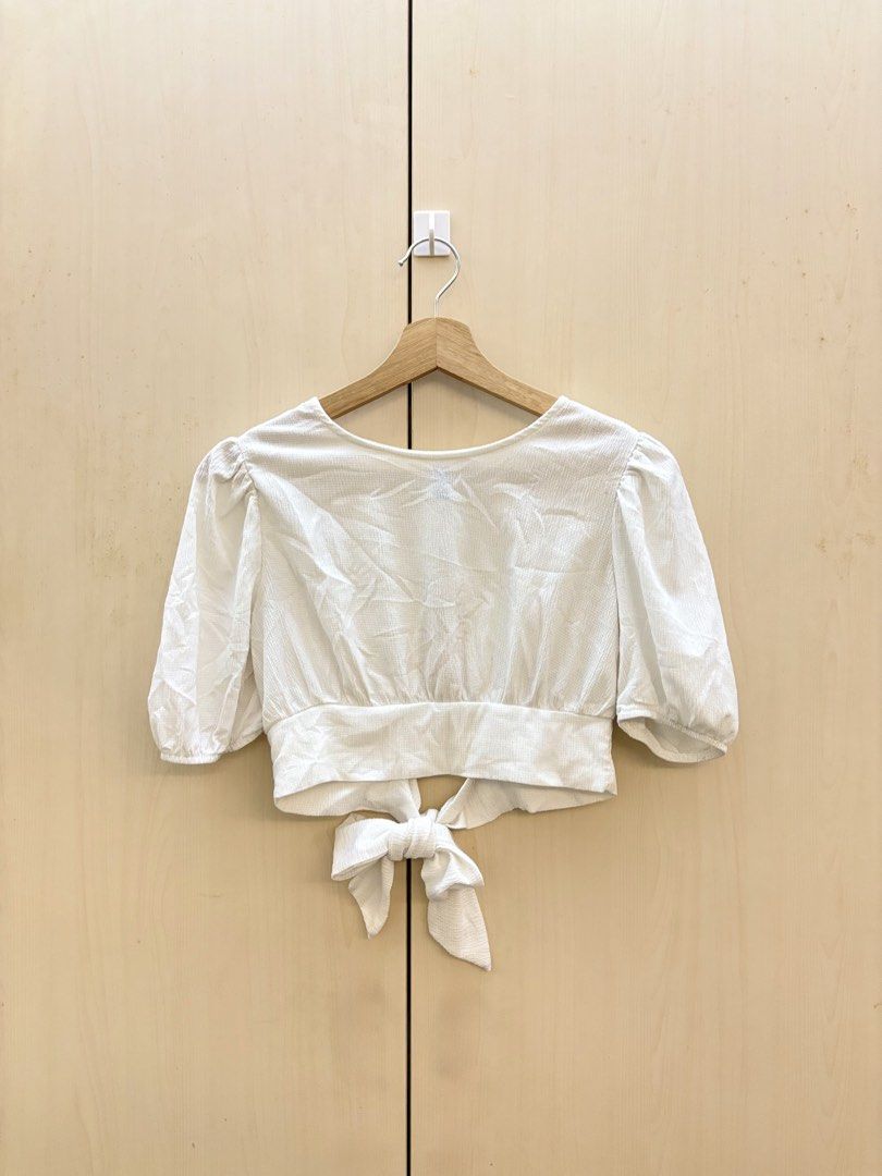 White Puff Sleeve Tie Back Crop Top (Category: Blouses) located in Manila. Submitted by amityclutter (Listing ID 1461945158, Image 1). Description: - Adorable white crop top - Features charming puff sleeves - Stylish tie-back detail at the waist - Subtle textured fabric for added detail - Perfect for casual outings or dressing up - Effortlessly pairs with jeans or skirts.