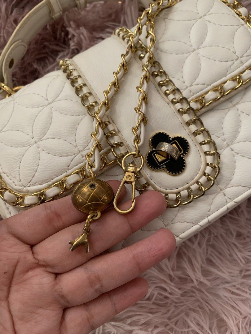 White Quilted Handbag with Gold Chain Strap (Category: Luxury Bags & Wallets) located in Manila. Submitted by _xsleey (Listing ID 1461914365, Image 2). Description: - White quilted handbag with a beautiful floral pattern. - Elegant gold chain strap. - Decorative clasp for a touch of style. - Adorable globe and bird charm attached. - Interior features multiple compartments for organization. - Includes a convenient zipper pocket. - Brand label insi