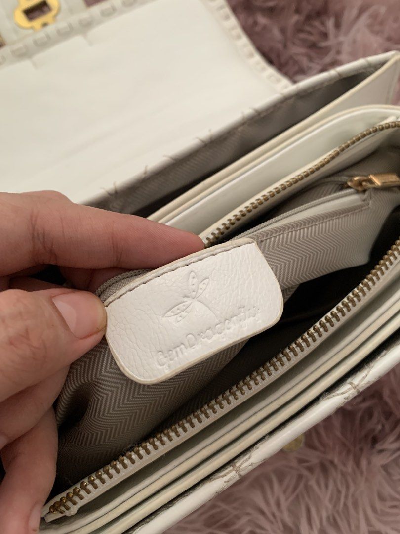 White Quilted Handbag with Gold Chain Strap (Category: Luxury Bags & Wallets) located in Manila. Submitted by _xsleey (Listing ID 1461914365, Image 3). Description: - White quilted handbag with a beautiful floral pattern. - Elegant gold chain strap. - Decorative clasp for a touch of style. - Adorable globe and bird charm attached. - Interior features multiple compartments for organization. - Includes a convenient zipper pocket. - Brand label insi