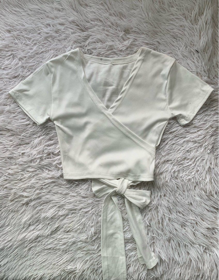 White Ribbed Short Sleeve Wrap Crop Top (Category: Blouses) located in San Carlos. Submitted by findsbymiles (Listing ID 1461895689, Image 1). Description: size: small-medium no issues sf will be shouldered by the buyer mop: gcash | mod: jnt delivery 📍san carlos, pangasinan.