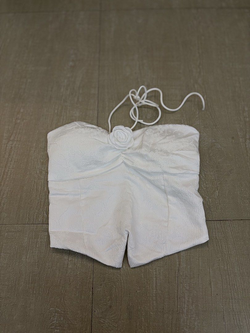 White Ruched Halter Top with Rose Detail (Category: Sleeveless) located in Manila. Submitted by amityclutter (Listing ID 1461911072, Image 1). Description: - White halter top - Ruched bust with central rose detail - Textured fabric - Ties at the neck - Ideal for night outs or special occasions - Chic and stylish.