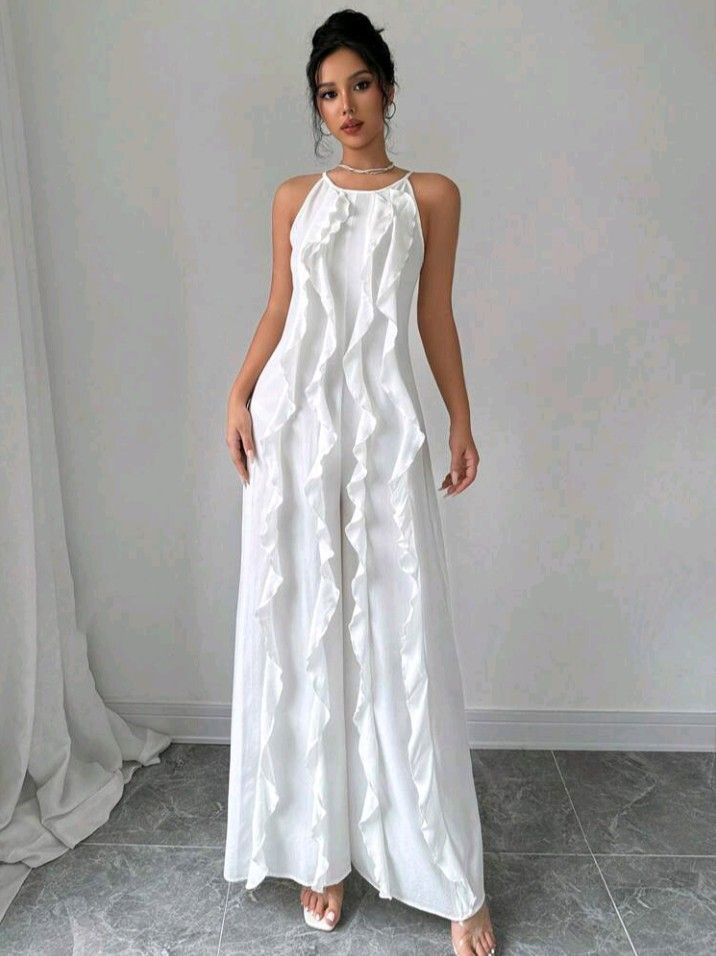 White Ruffle Halter Neck Wide Leg Jumpsuit (Category: Jumpsuits) located in Manila. Submitted by prelovedbypoliiii (Listing ID 1461968596, Image 1). Description: - White halter neck jumpsuit - Ruffle detailing down the front - Wide leg pants - Zipper closure at the back - Ideal for parties or a night out - Chic and flowy design.