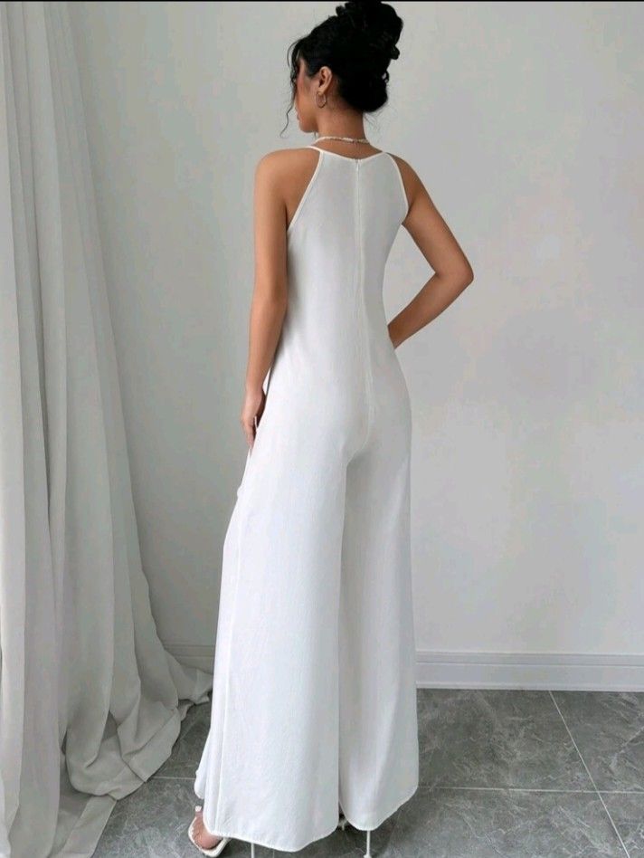 White Ruffle Halter Neck Wide Leg Jumpsuit (Category: Jumpsuits) located in Manila. Submitted by prelovedbypoliiii (Listing ID 1461968596, Image 2). Description: - White halter neck jumpsuit - Ruffle detailing down the front - Wide leg pants - Zipper closure at the back - Ideal for parties or a night out - Chic and flowy design.