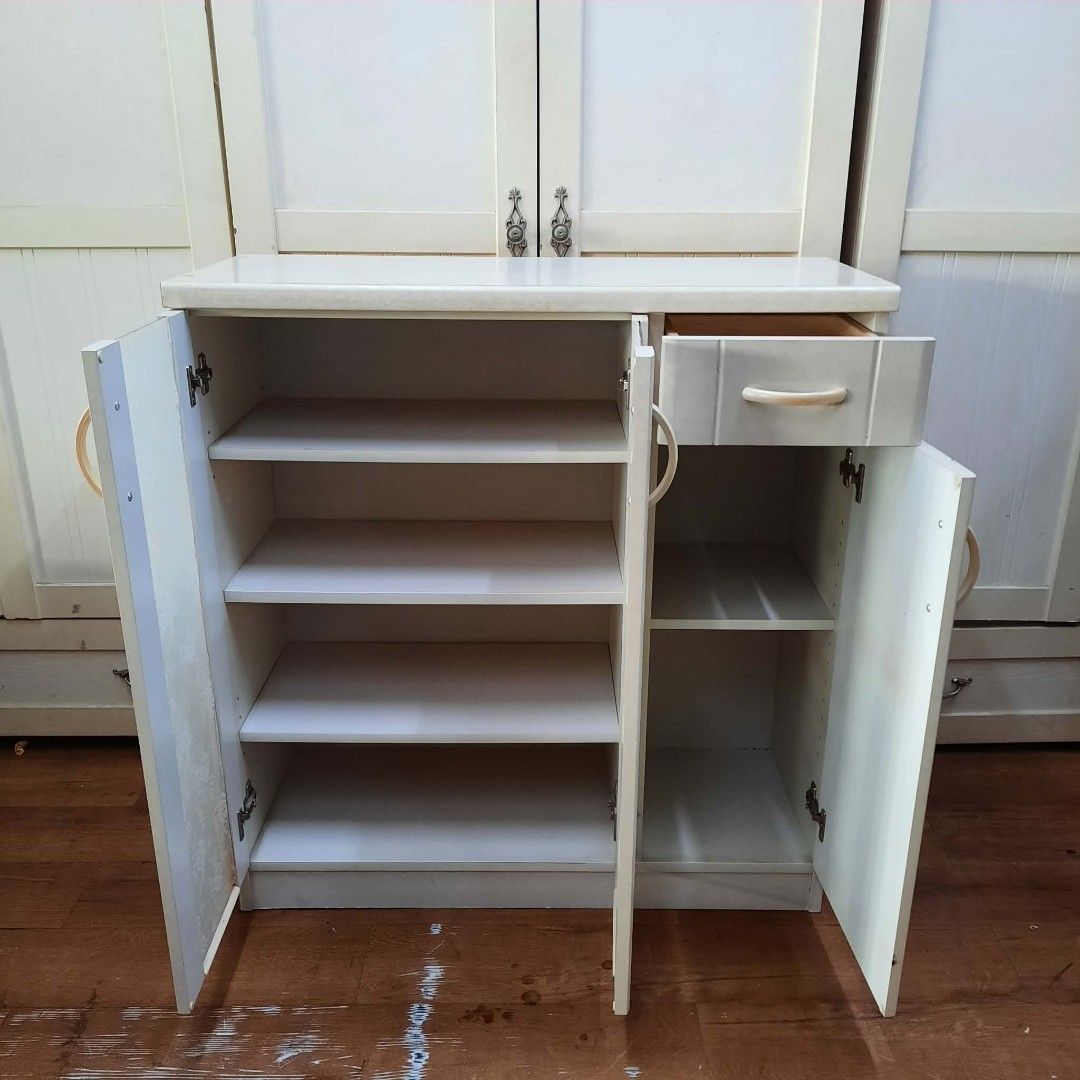 White Storage Cabinet with Glass Doors and Drawer (Category: Shelves, Cabinets & Racks) located in Manila. Submitted by ivan_furnitures421 (Listing ID 1461897663, Image 3). Description: - Elegant white storage cabinet - Features two glass doors with a beautiful floral lace pattern on the left - One door with an integrated drawer on the right - Offers generous shelf space for organized storage - Ideal for use in the kitchen or living room - Compac