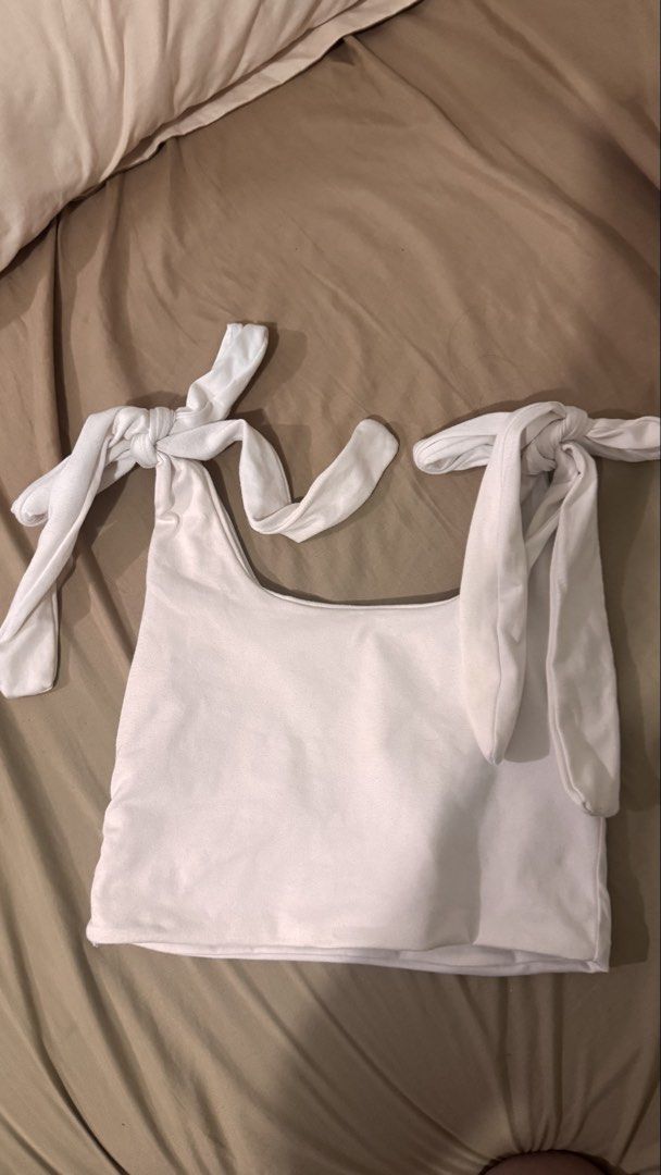 White Tie Shoulder Top (Category: Blouses) located in Manila. Submitted by flyingyvon (Listing ID 1461940660, Image 1). Description: - Soft fabric white top - Tie shoulder straps for adjustable fit.