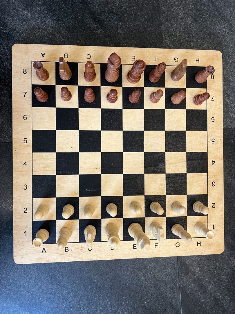Wooden Chess Set with Pieces (Category: Board Games & Puzzles) located in Pasig City. Submitted by yonghan0613 (Listing ID 1461905940, Image 1). Description: - Classic wooden chess board and pieces - Includes all standard light and dark side pieces - Board features clear coordinate markings - Ideal for game nights or as a decorative item - Ready for your next chess match.