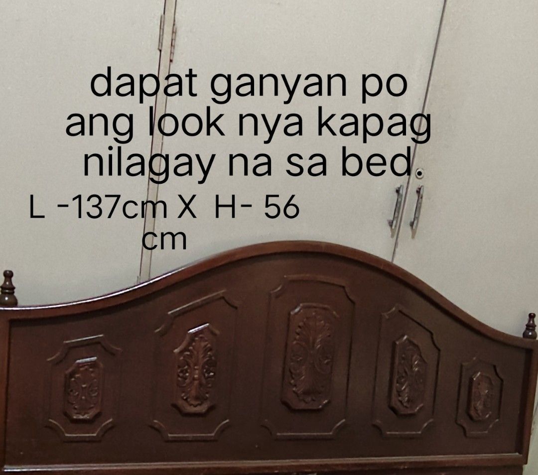 Wooden Headboard - Queen Size (Category: Bed Frames & Mattresses) located in Manila. Submitted by nancyolireal (Listing ID 1461950685, Image 1). Description: - Elegant dark wood headboard with a curved top and intricate carved panels. - Perfectly sized for a queen-size bed, measuring 137cm wide and 56cm high. - Crafted from durable solid wood for lasting quality. - Shows some minor signs of wear on the bottom panels, but it will not show once pla