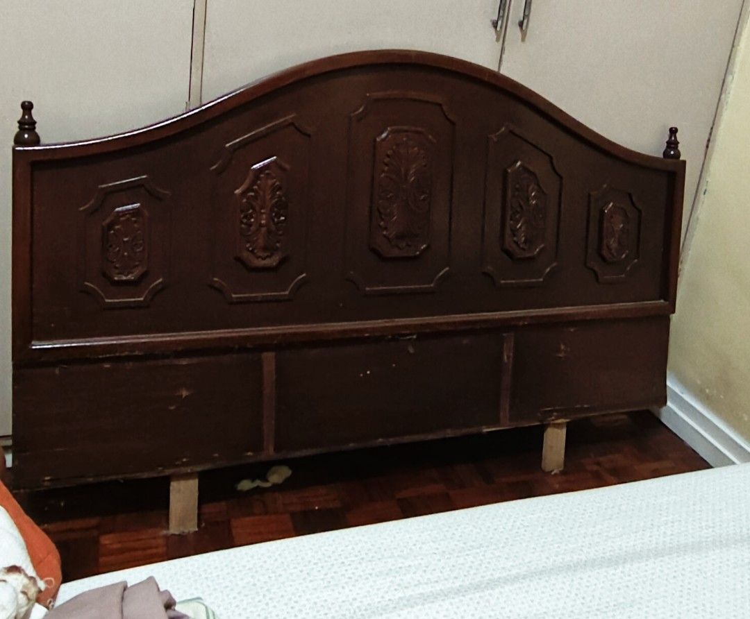 Wooden Headboard - Queen Size (Category: Bed Frames & Mattresses) located in Manila. Submitted by nancyolireal (Listing ID 1461950685, Image 2). Description: - Elegant dark wood headboard with a curved top and intricate carved panels. - Perfectly sized for a queen-size bed, measuring 137cm wide and 56cm high. - Crafted from durable solid wood for lasting quality. - Shows some minor signs of wear on the bottom panels, but it will not show once pla