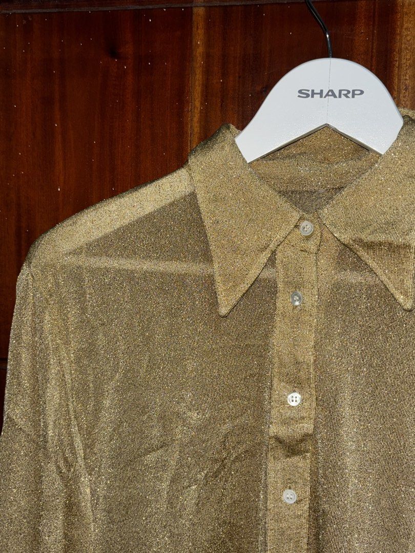 Y2K Gold Sparkly Sheer Button-Up Shirt (Category: Blouses) located in Bauang. Submitted by crazeymuffin (Listing ID 1461806460, Image 2). Description: Gold sparkly sheer shirt. Long sleeves with button cuffs. Classic collar and button-down front. Looks great layered or on its own. Adds a bit of glam to any outfit. Perfect for parties or a night out..