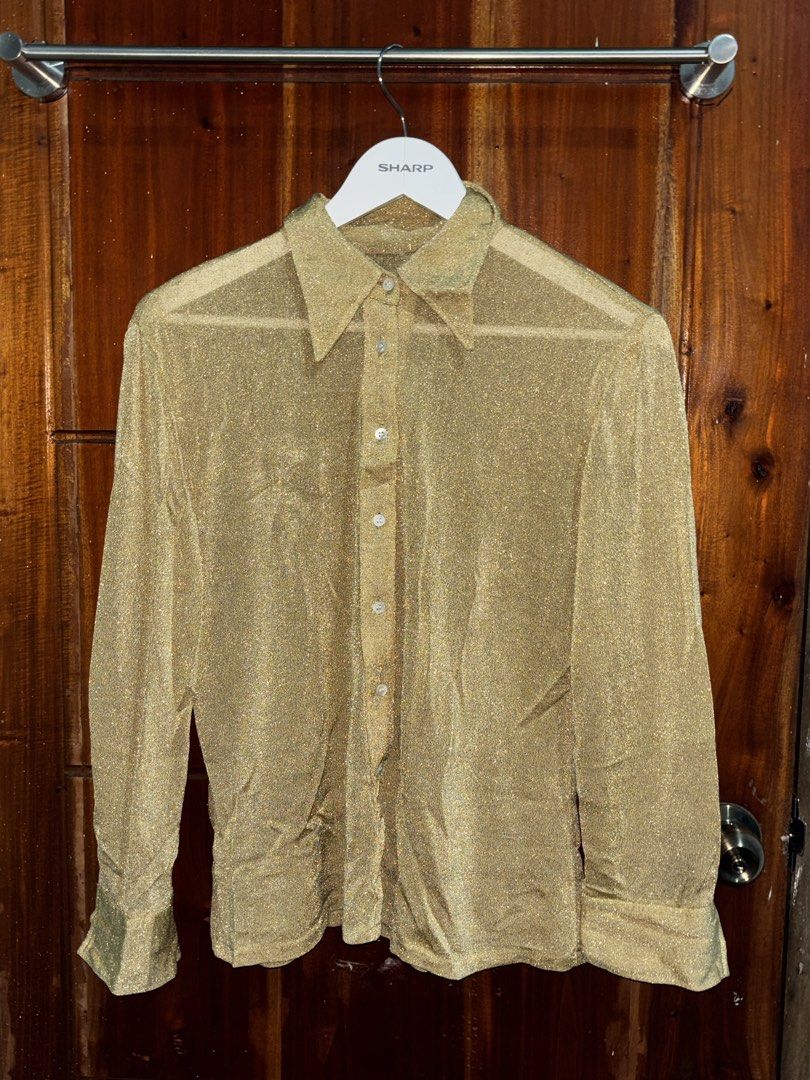 Y2K Gold Sparkly Sheer Button-Up Shirt (Category: Blouses) located in Bauang. Submitted by crazeymuffin (Listing ID 1461806460, Image 1). Description: Gold sparkly sheer shirt. Long sleeves with button cuffs. Classic collar and button-down front. Looks great layered or on its own. Adds a bit of glam to any outfit. Perfect for parties or a night out..