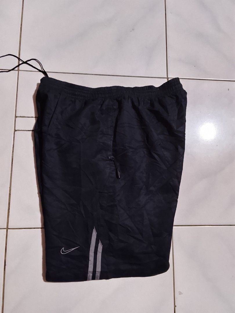 Y2k vintage shorts (Category: Shorts) located in Cavite. Submitted by ara.thrifts (Listing ID 1461814386, Image 1). Description: - Black Nike track shorts - Size XXL width "17" length "22" no issue bnew 10/10 cr - Features Nike logo on left leg - Reflective stripes on the side - Elastic waistband with drawstring - Perfect for sports or casual wear - Made in Hong Kong.