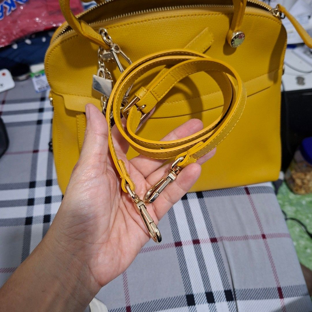 Yellow Leather Handbag with Charms (Category: Shoulder Bags) located in Las Pinas. Submitted by jgz21 (Listing ID 1461813661, Image 3). Description: - Bright yellow leather handbag - Versatile: Top handle and detachable shoulder strap - Adorable metal charms included - Secure zip-top closure - Elegant gold hardware details - Protective feet on the bottom - Ideal for daily use.