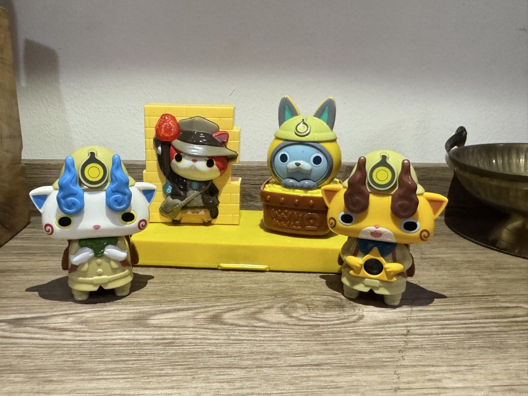Yo-kai Watch Figures with Display Stand (Category: Figurines & Statues) located in Quezon City. Submitted by kcapi (Listing ID 1461958433, Image 1). Description: - Set of Yo-kai Watch figures - Includes yellow display stand with brick wall design - Figures feature movable parts and accessories - Display stand - All included pieces are visible in the provided photos - Perfect for Yo-kai Watch collectors and fans.
