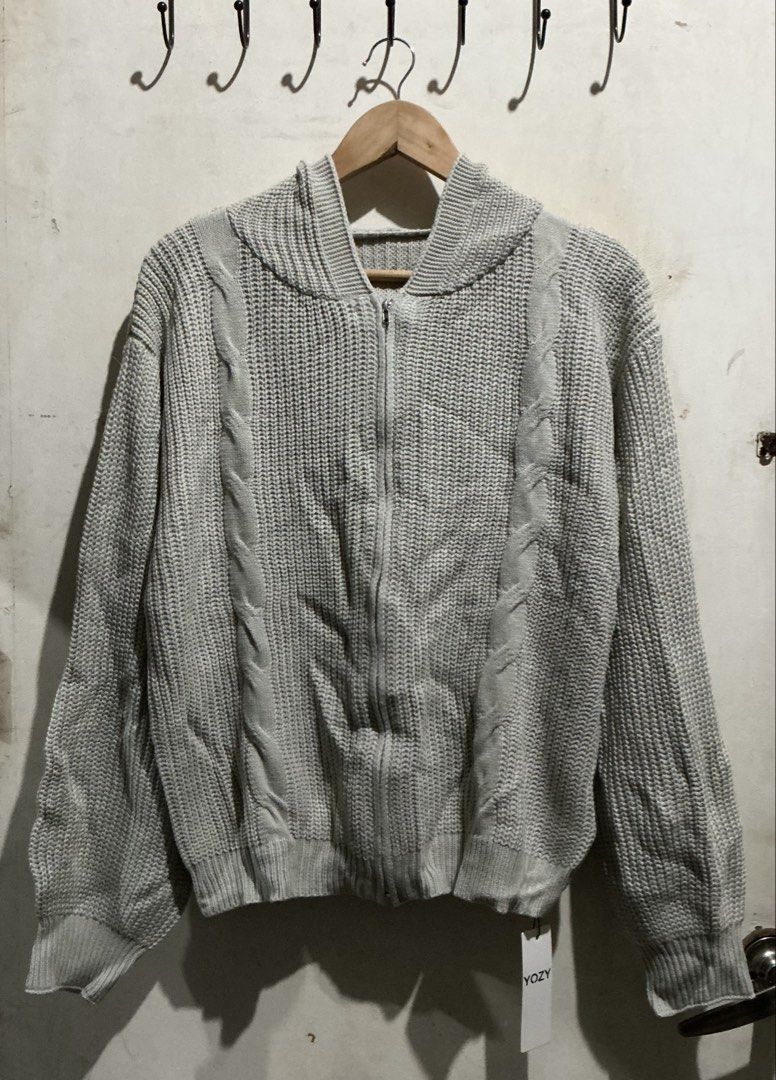YOZY KNITTED SWEATER (Category: Coats, Jackets and Outerwear) located in Dagupan City. Submitted by trendies_collection (Listing ID 1462004705, Image 1). Description: Brand new with pouch and hang tag Large on tag, fit up to xl No issue Light gray actual color Light weight knitted.