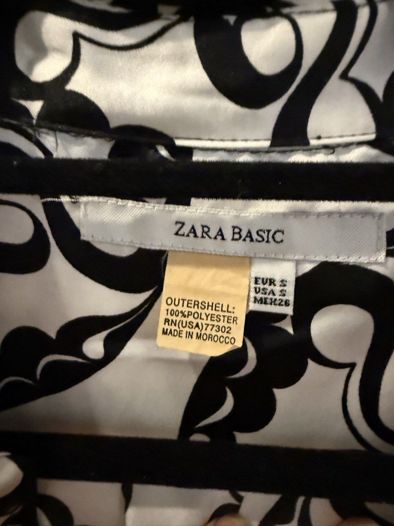 ZARA BASIC Black & White Print Shirt Dress (Category: Dresses) located in Makati City. Submitted by jcalmartz (Listing ID 1461813003, Image 3). Description: - Brand: ZARA BASIC - Style: Print Shirt Dress - Color: Black and White - Material: 100% Polyester - Neckline: Collared - Closure: Button-up front - Sleeves: 3/4 length with elastic cuffs - Measurements: 35 inches (length), 14 inches (pit to pit) - Versatility: Perfect for casual or dressed-u