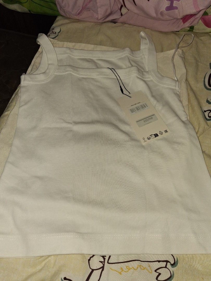 Zara White Ribbed Tank Top with Tags (Category: Sleeveless) located in Mandaluyong City. Submitted by hinalmhary33271 (Listing ID 1462021759, Image 2). Description: - Brand new Zara ribbed tank top - Original tags still attached - Comfortable, stretchy material - Square neckline with thin straps - Comes with a reusable Zara dust bag - Essential basic piece for any wardrobe.