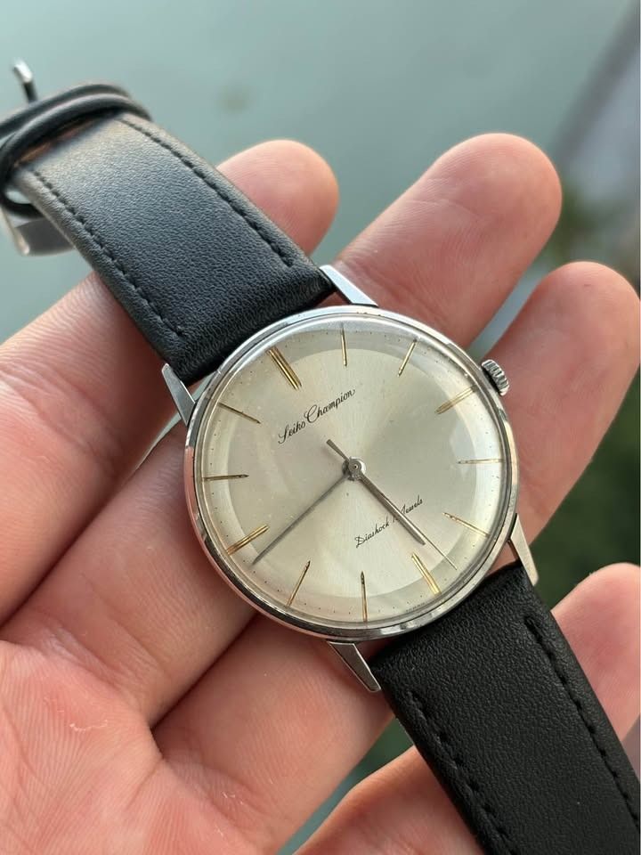 1960’s Seiko Champion (Category: Luxury Watches) located in Manila. Submitted by archi.math (Listing ID 1462179723, Image 1). Description: * Manual-wind mechanical movement * 17 jewels * Classic silver dial with gold-tone applied markers * Original vintage dial & hands * Stainless steel case * Clean minimalist vintage dress watch * Running condition * Fitted with new black leather strap .