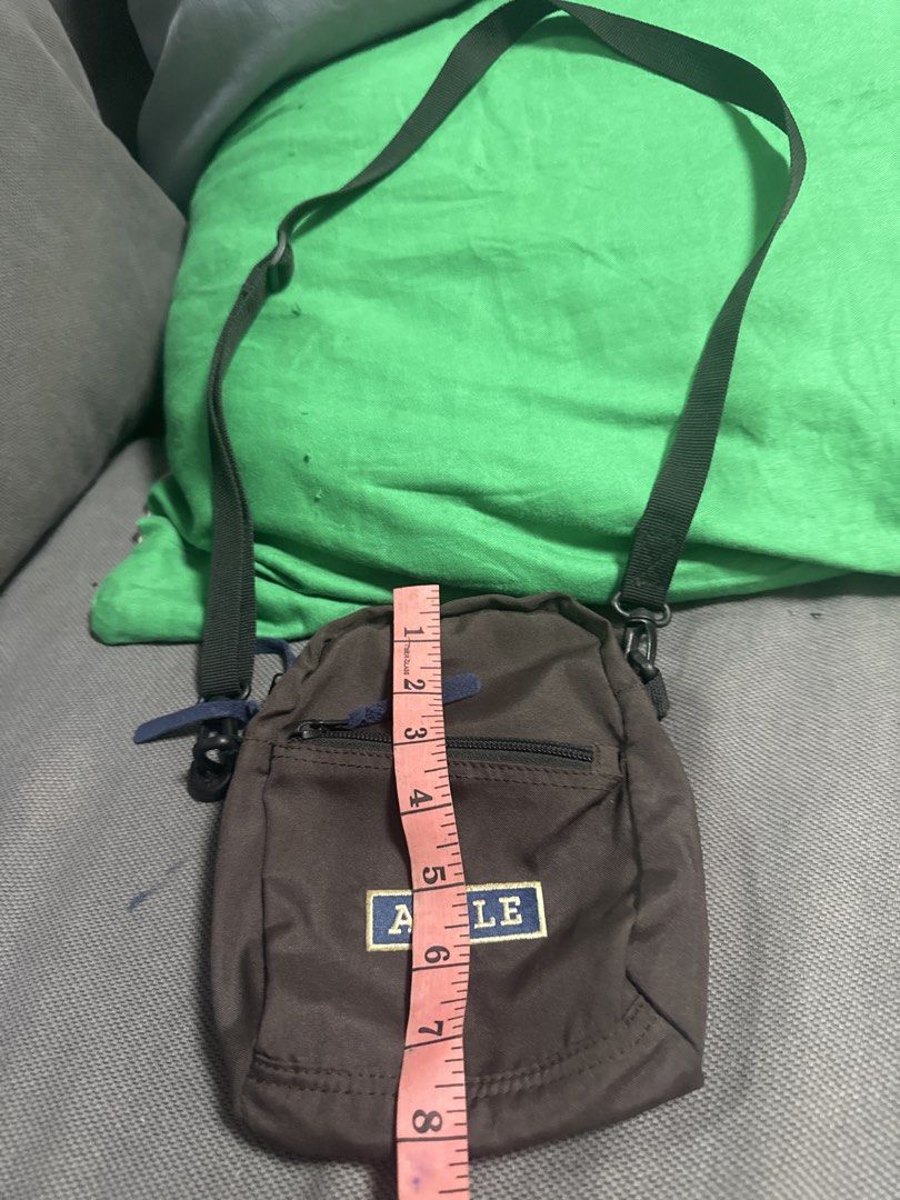 2027 AIGLE Brown Crossbody Bag (Category: Cross-body Bags) located in Silang. Submitted by sari2bilina (Listing ID 1462155659, Image 1). Description: - Brand: AIGLE - Color: Brown - Style: Crossbody bag - Features: Main zippered compartment, front zippered pocket - Strap: Adjustable - Size: Small and compact, approx. 7 inches tall x 5 inches wide - Ideal for: Carrying essentials.