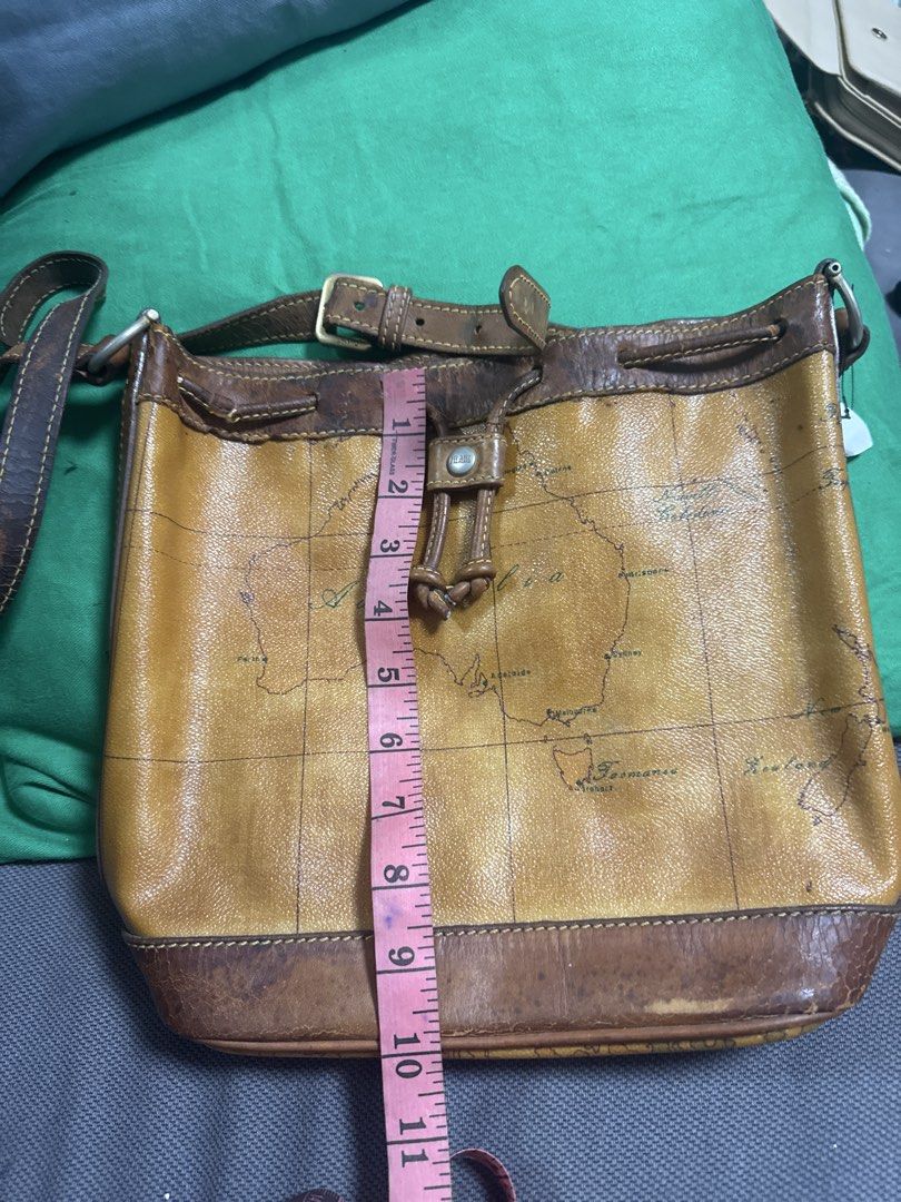 2027 Brown Leather Map Print Shoulder Bag (Category: Shoulder Bags) located in Silang. Submitted by sari2bilina (Listing ID 1462157189, Image 1). Description: - Stylish cool brown leather shoulder bag - Unique all-over map print design - Secure drawstring closure with buckle strap - Durable leather trim and strap - Convenient interior zippered pocket - Approximate dimensions: 10 inches wide x 9 inches tall flaws last 2 pics.