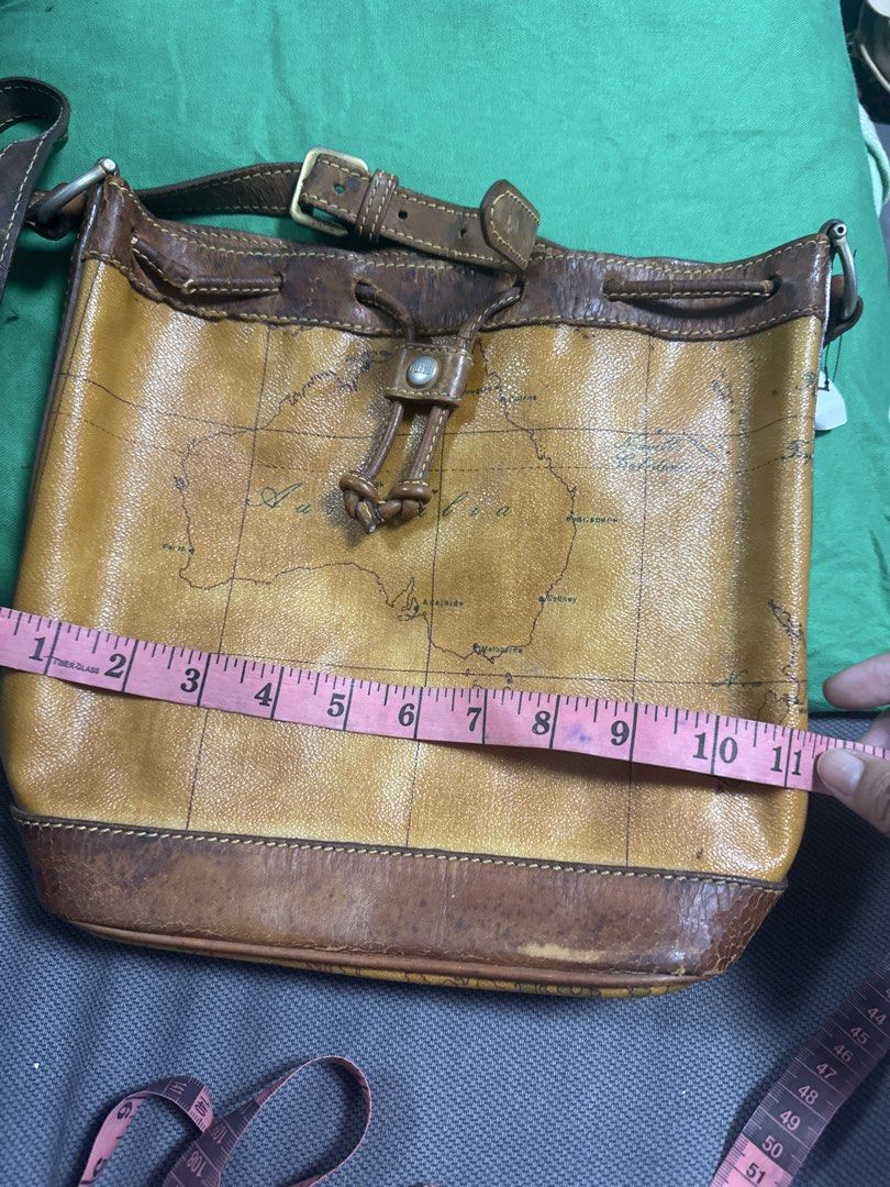 2027 Brown Leather Map Print Shoulder Bag (Category: Shoulder Bags) located in Silang. Submitted by sari2bilina (Listing ID 1462157189, Image 2). Description: - Stylish cool brown leather shoulder bag - Unique all-over map print design - Secure drawstring closure with buckle strap - Durable leather trim and strap - Convenient interior zippered pocket - Approximate dimensions: 10 inches wide x 9 inches tall flaws last 2 pics.