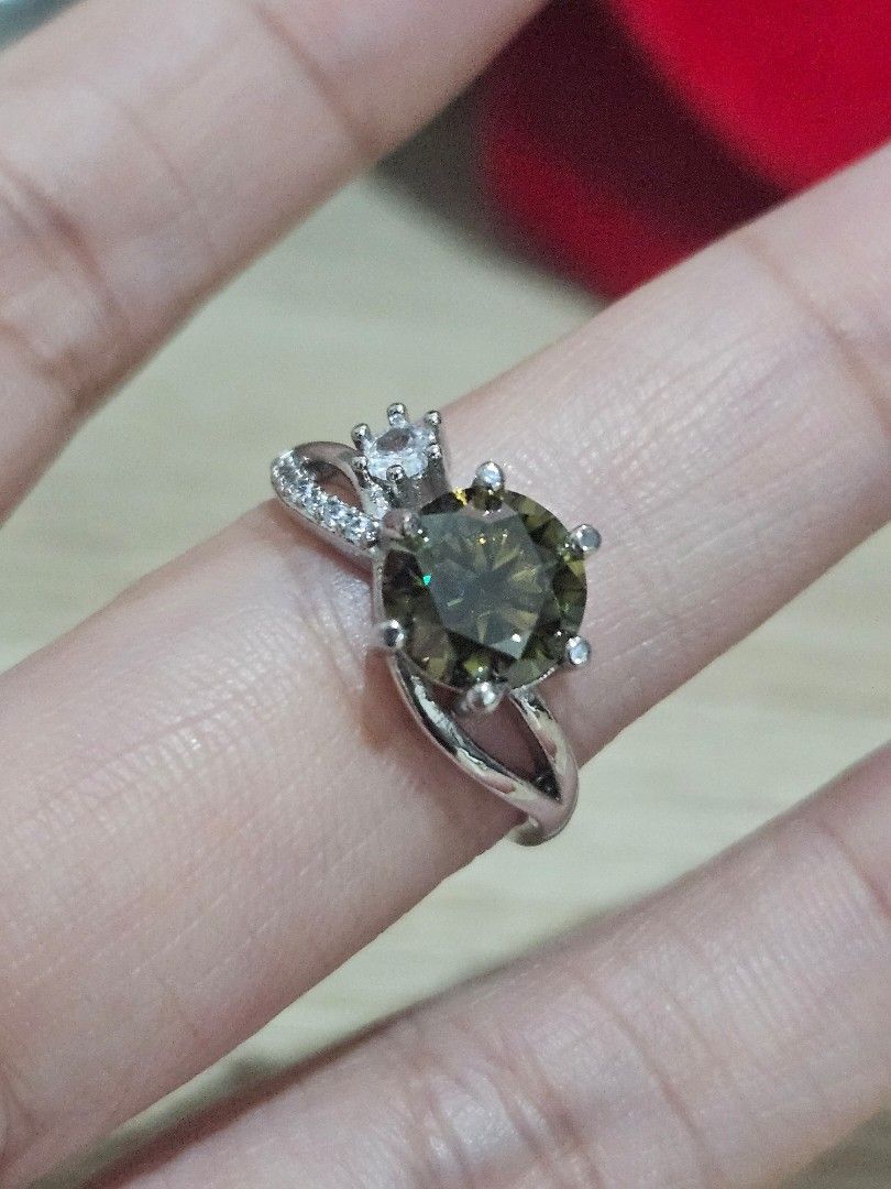 2ct Dark Green Moissanite Stone Simple Ring (Category: Rings) located in Cainta. Submitted by Kahi0410 (Listing ID 1462233760, Image 2). Description: Moissanite Stone Round Brilliant cut PT950 marked Adjustable ring Hypoallergenic Passed Diamond Test.