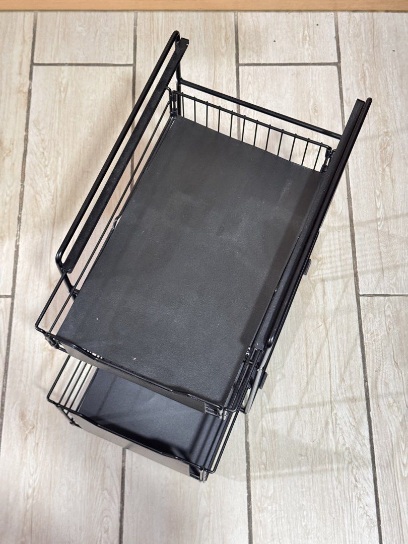 2-Tier Pull-Out Storage Rack Organizer (Category: Shelves, Cabinets & Racks) located in Manila. Submitted by maichandise (Listing ID 1462183679, Image 3). Description: - Black metal 2-tier pull-out storage rack - Ideal for organizing under sinks and in cabinets - Great for kitchens, bathrooms, and pantries STILL NEGOTIABLE ☺️.