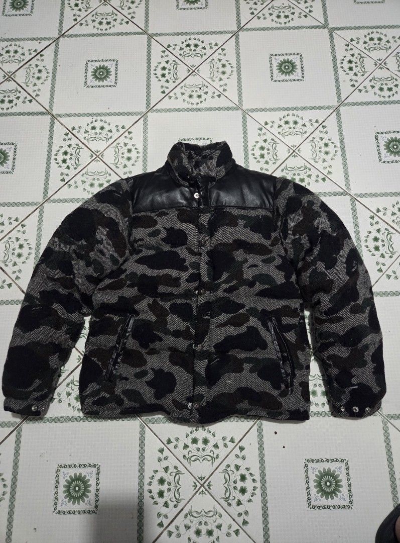 A BATHING APE Camo Wool Down Jacket Size M (Category: Coats, Jackets and Outerwear) located in Baguio. Submitted by muzaffarjahan (Listing ID 1462182377, Image 1). Description: - Authentic BAPE Down Jacket - Eye-catching camouflage pattern - Premium wool blend fabric (90% wool, 10% nylon) - Stylish leather collar accents - Warm and lightweight: 80% down, 20% feather fill - Size: Medium (M) - Made in China - Perfect for staying warm and fashionabl