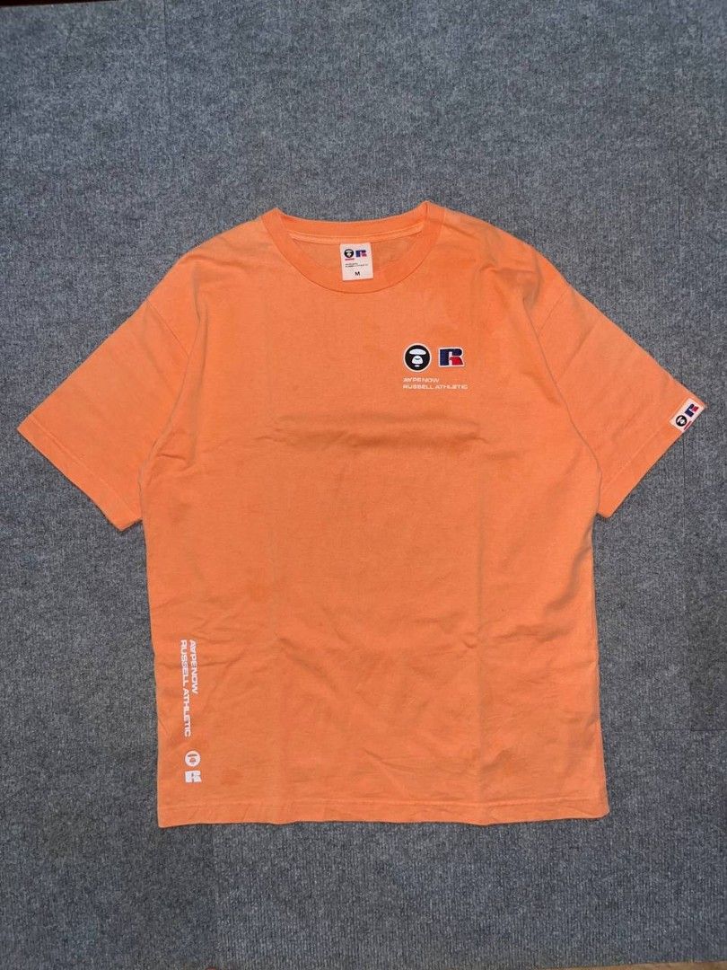 Aape × Russell Athletic (Category: Tshirts & Polo Shirts ) located in Getafe. Submitted by charlon_thrift (Listing ID 1462072825, Image 1). Description: For Sale♻️ Aape × Russel Athletic💢 Excellent condition 9.5/10 Color rate Dimes W22.5 / L29 ~baby hairlines 450+sf only DM📥.