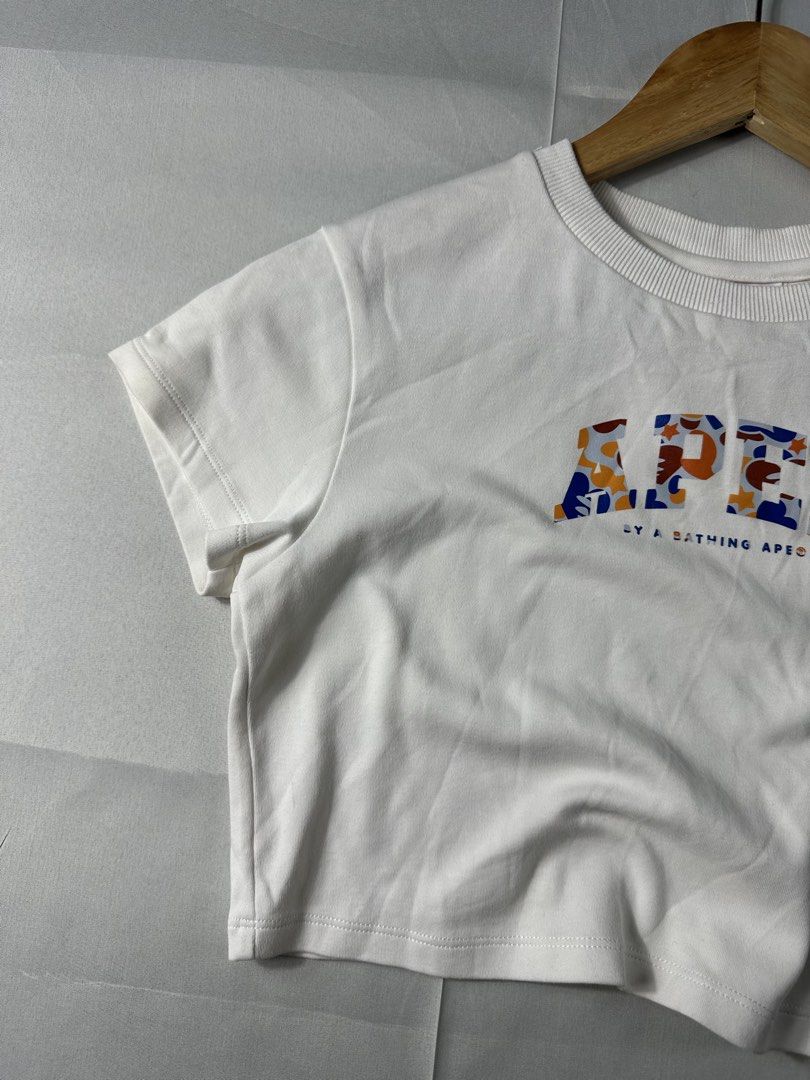 Aape Y2K White Printed Cropped Shirt (Category: Others Tops) located in Cabanglasan. Submitted by thefashiongarage.co (Listing ID 1462132691, Image 3). Description: Title - Aape Y2K Printed Cropped Shirt Model/Name - Cropped Shirt Size on Tag - Small Conditiion - Excellent Condition Dimension (LxWxH) - 16x14.5 Inches Category- Cropped Shirt Fitting - True to size Made in - China Material - 97% Cotton/ 3% Spandex Color - White Design - Printed Scr