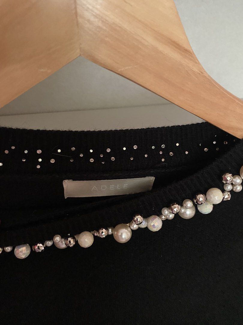 ADELE Black Pearl Embellished Crewneck Sweater (Category: Longsleeves) located in Iloilo. Submitted by luckyeagle_1c5618 (Listing ID 1462147120, Image 3). Description: - ADELE black crewneck sweater - Pearl and rhinestone embellishments around the neckline - Long sleeves with pearl details at the cuffs - Soft knit fabric - Versatile for dressing up or down.