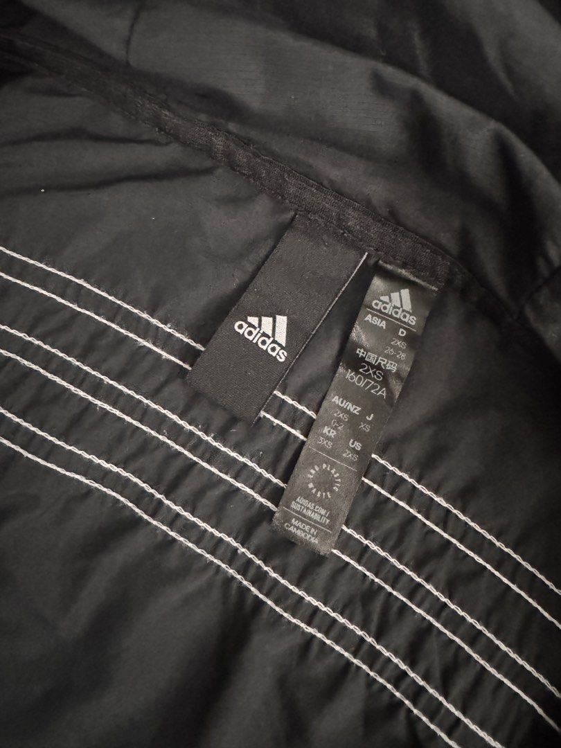 Adidas Black Windbreaker Jacket with 3 Stripes (Category: Coats, Jackets and Outerwear) located in Dumaguete. Submitted by dayvi143 (Listing ID 1462261437, Image 3). Description: - Preloved - Classic black Adidas windbreaker jacket - Iconic 3 stripes on sleeves and back - Built-in hood for extra protection - Adjustable drawstring at the hem for a custom fit - Lightweight material, ideal for layering - Versatile for casual outings or athletic acti