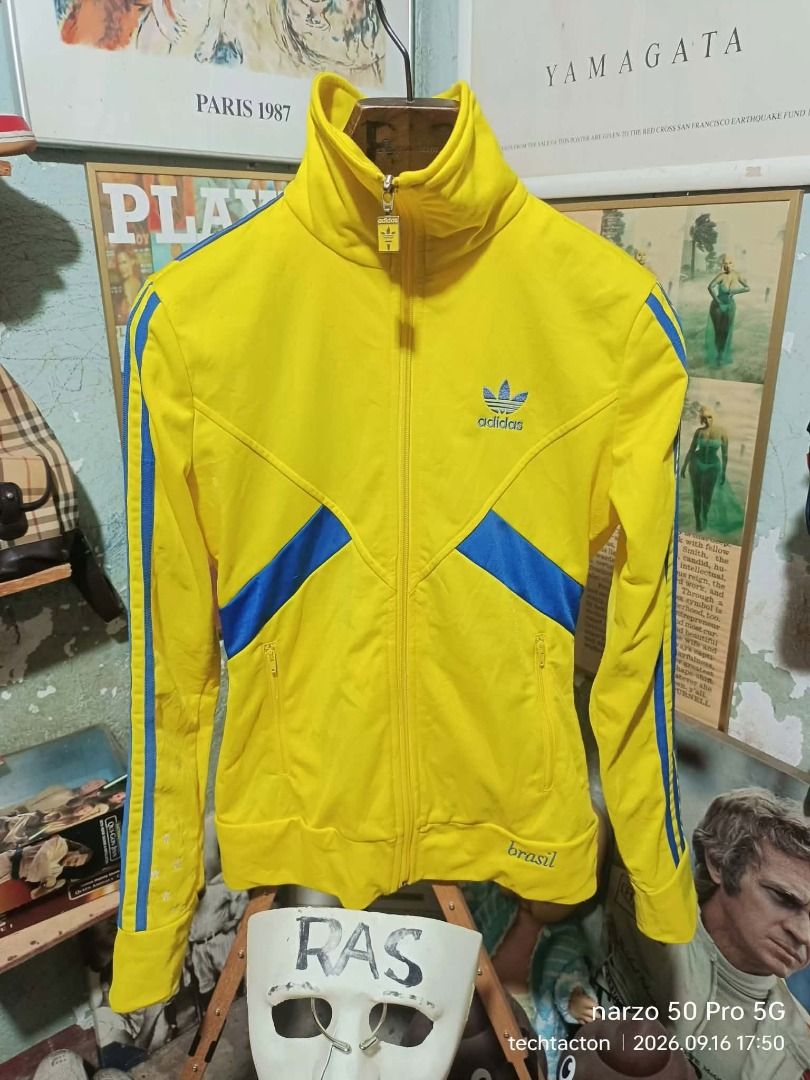 Adidas Brasil Track Jacket Yellow Blue (Category: Coats, Jackets and Outerwear) located in Santo Tomas. Submitted by pickers_corner (Listing ID 1462182380, Image 1). Description: ADIDAS Brazil womens Track jacket size 85 dime 17.5x23.5 very good condition no holes no stain issue minimal sign of used or molmol - Yellow Adidas track jacket - Blue accents - Brasil flag design on back with 'Ordem e Progresso' - Zip-up front with Adidas logo zipper pu